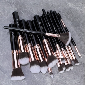 Detail of professional black and rose gold makeup brushes with synthetic dual-tone bristles