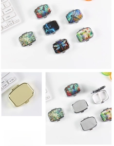 Detail of portable metal pill box showing colorful animal patterns and dual compartments