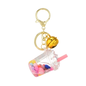 Creative bubble tea keychain with colorful sand, liquid filling, and golden metal bell