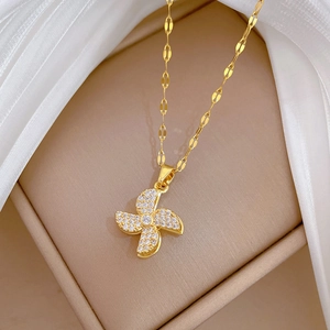 Close-up of a rotating windmill pendant necklace with sparkling zircons in a jewelry box