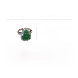 Macro shot of green resin gourd ring with white zircon pave setting and brass material