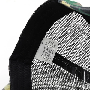 Detailed macro view showing the 65% cotton fabric label and breathable mesh of the camo cap
