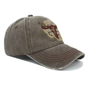 Detailed macro view of vintage washed cotton fabric and bull skull embroidery on baseball cap