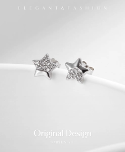 Detailed view of S925 sterling silver star earrings with half-pave cubic zirconia inlay