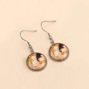 Detail view of round vintage ear hook earrings featuring Klimt The Kiss painting