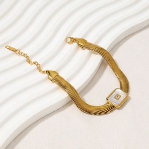 Gold wide snake chain bracelet with shell inlay and cubic zirconia on wavy board