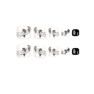 Ink leaf black and white press-on toenails set featuring artistic patterns and solid colors