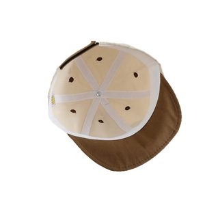 Interior view of two-tone baby baseball cap showing brown corduroy brim and reinforced seams