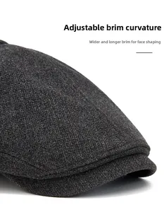 Detailed side view of charcoal wool newsboy cap showing wide curved brim features