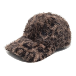 Close-up of the fluffy faux fur leopard print texture on a winter baseball cap