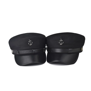 Detail of black captain hat with silver anchor badge and leather strap decoration