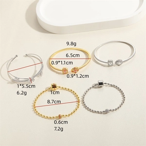 Chic set of gold and silver bracelets featuring cubic zirconia and geometric floral charms