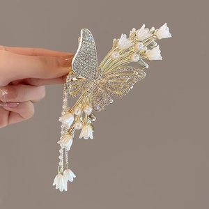 Golden butterfly hair claw clip with lily of the valley tassels and sparkling rhinestones