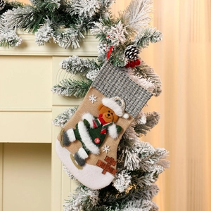 Detail of burlap Christmas stocking featuring 3D teddy bear with Merry Christmas sign