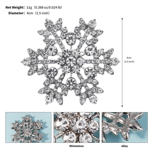 Detailed macro view showing a 4cm snowflake brooch with silver alloy and rhinestones