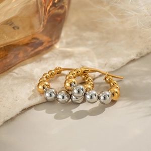 Two-tone mixed gold and silver beaded hoop earrings with a metallic finish for women
