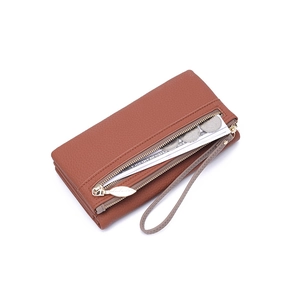 Detail view of caramel brown lychee leather long wallet with leaf zipper and wrist strap