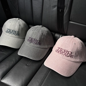 Detailed close-up of three canvas baseball caps with 3D Zero Garage embroidery