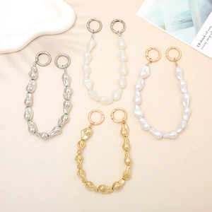 Close-up of four baroque irregular bead chains in gold, silver, pearl, and iridescent finishes