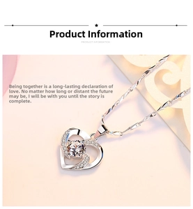Detailed macro view of heart pendant with central sparkling crystal and pavé accents
