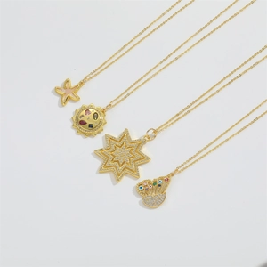 Detailed close-up of four gold necklaces featuring starfish, sun, and star pendants with gems