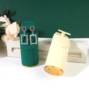 Vertical jewelry display stands in green and cream velvet with golden metal base