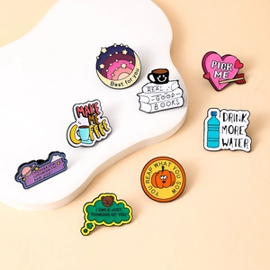 Set of colorful enamel alloy pins with motivational quotes on a white cloud stand