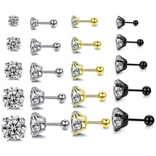 Detail of round cubic zirconia stud earrings in silver, gold, and black steel finishes
