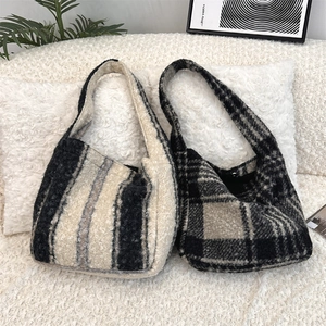 Detail of wool plush tote bags in striped and plaid patterns for autumn and winter