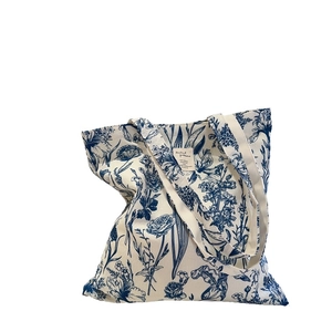 Eco-friendly canvas tote bag with elegant blue floral print and dual shoulder straps