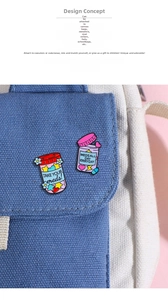 Detail of colorful enamel medicine bottle pins with stars and text on blue fabric