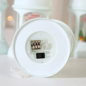 Detail of white plastic base with battery compartment and power switch for LED lantern