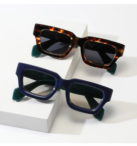 Macro shot of square frame sunglasses showing detailed temple specs and blue finish