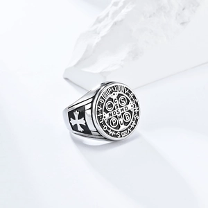Macro shot of silver St. Benedict exorcist ring with vintage finish on white stone