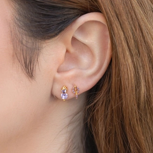 Exquisite gold earrings set featuring a purple heart gem and a jewel-encrusted sword design