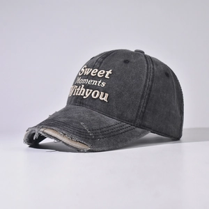 Close-up of Sweet Moment embroidery on vintage washed cotton baseball cap with worn edges