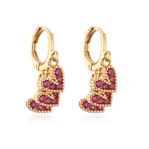 Detail of 18K gold plated hoop earrings featuring three vibrant pink heart zircons