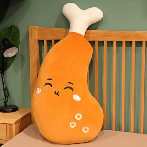 Detail view of a large cartoon chicken leg plush pillow skin leaning on a bed.