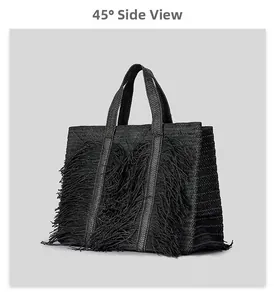 Detail of 45-degree side view showing black woven tote bag with fringe accents