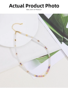 Detail of natural stone beaded necklace with gold plated clasp and extension chain