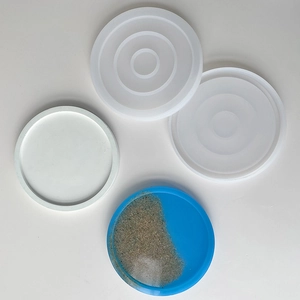 Top view of round silicone coaster mold set with blue resin diy craft demonstration