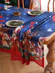 Detailed Christmas tablecloth with bear and gift patterns on a festive holiday dinner table