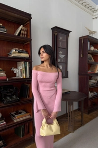 Detailed texture of pink ribbed knit off-shoulder top and matching skirt set for women