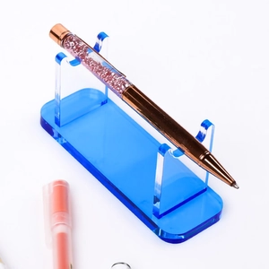 Blue acrylic fountain pen display stand with double-slot support on white background