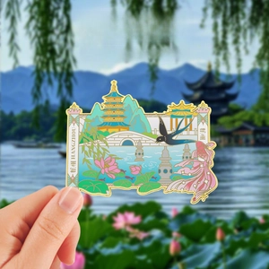 Macro detail of Hangzhou West Lake souvenir magnet with enamel Leifeng Pagoda and lotus