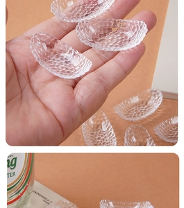 Detailed macro view of a miniature embossed crescent glass bowl held by hand for DIY crafts