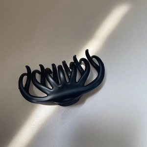 Elegant large black hair claw clip for women featuring a minimalist cutout design