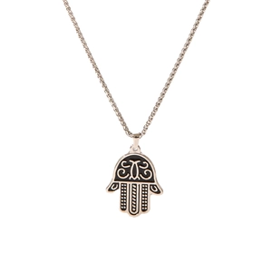 Macro shot of silver Hamsa hand pendant with black enamel details and chain texture