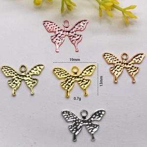 Detailed view of butterfly pendants in gold, silver, and copper with size 19x13mm