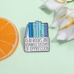 Enamel book brooch with Read Books and Dismantle Systems slogan in blue colors